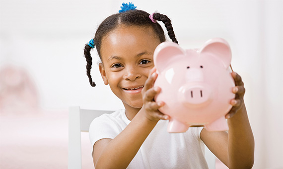 Child Holding Piggy Bank