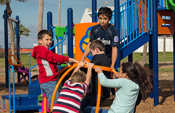 Children Using Commercial Playground Equipment